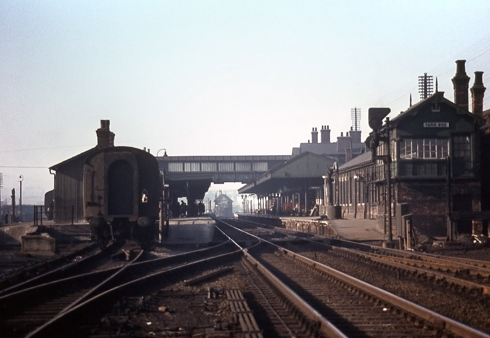 This view looking north through the Main Line platforms shows the Yard Box on the right and Grantham North in the distance. It also demonstrates the effect of the abrupt curvature of the line as it passes to the right of Grantham North box; a straight alignment would take the Down Main behind the box. Photograph taken by Noel Ingram on 1st March 1963, used with permission from Steam World.