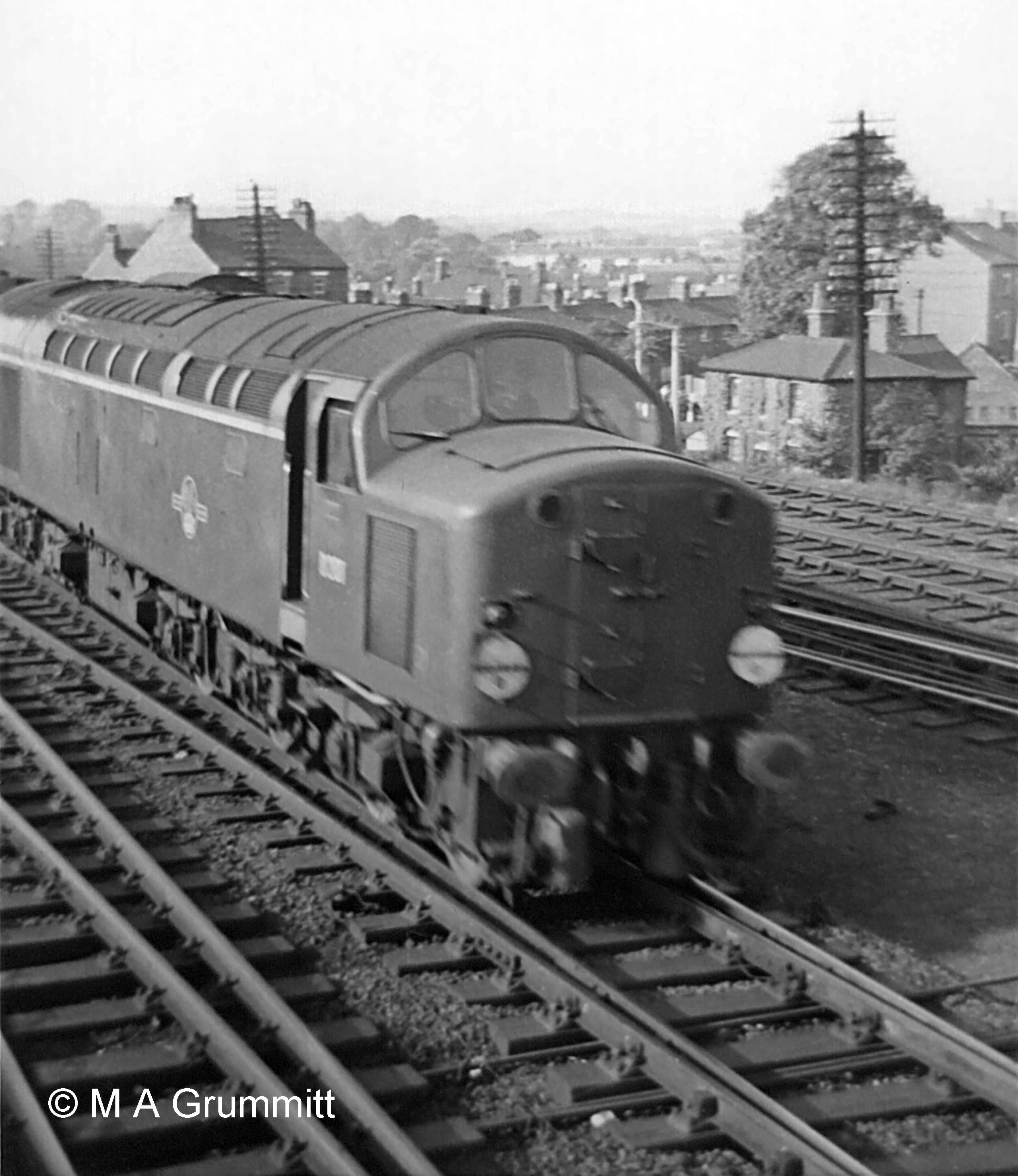 English Electric Type 4 (later Class 40) No. D208 heads south on the Up Main line. It is hauling an express passenger train, denoted by the two white discs, one above each buffer, which for a time were the equivalent of the headlamps used on steam locomotives. Photograph by Mick Grummitt.