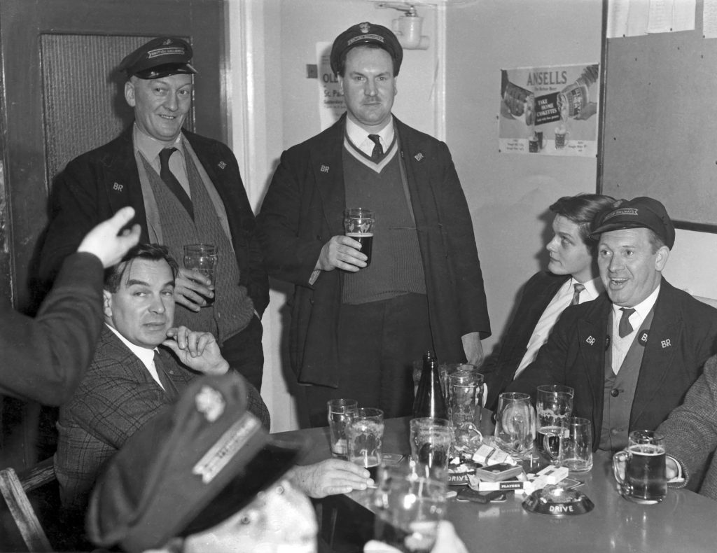 Cheers mate! At Grantham BRSA Club on 8th December 1966. Left to right drivers Ted Matsell (seated), Geordie Hope and Roy Veasey (both standing), Alan Lorne and driver Derek Bloodworth (both seated). Geordie Hope later became Club Steward. Photograph lent by Roy Veasey.