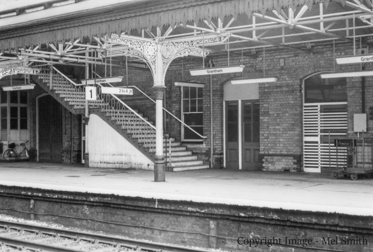A wider view of the stairs from platform 1 leading to the foot bridge across to platform 2. Again the Battery Room & Lobby doors are central to the photograph. The doors to the right lead to the "Cable Room" and "Telegraph Office" Copyright Image - Mel Smith