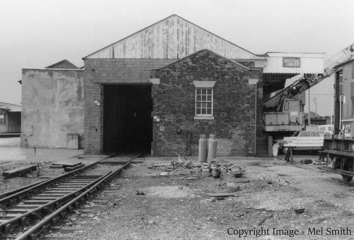 The end of our short walk along Station Road. We turn around to face the Goods Shed and Office. The now demolished Yard Box was situated to the left of this vantage point. The mobile cranes in the previous view can be seen on the right. Copyright Image - Mel Smith