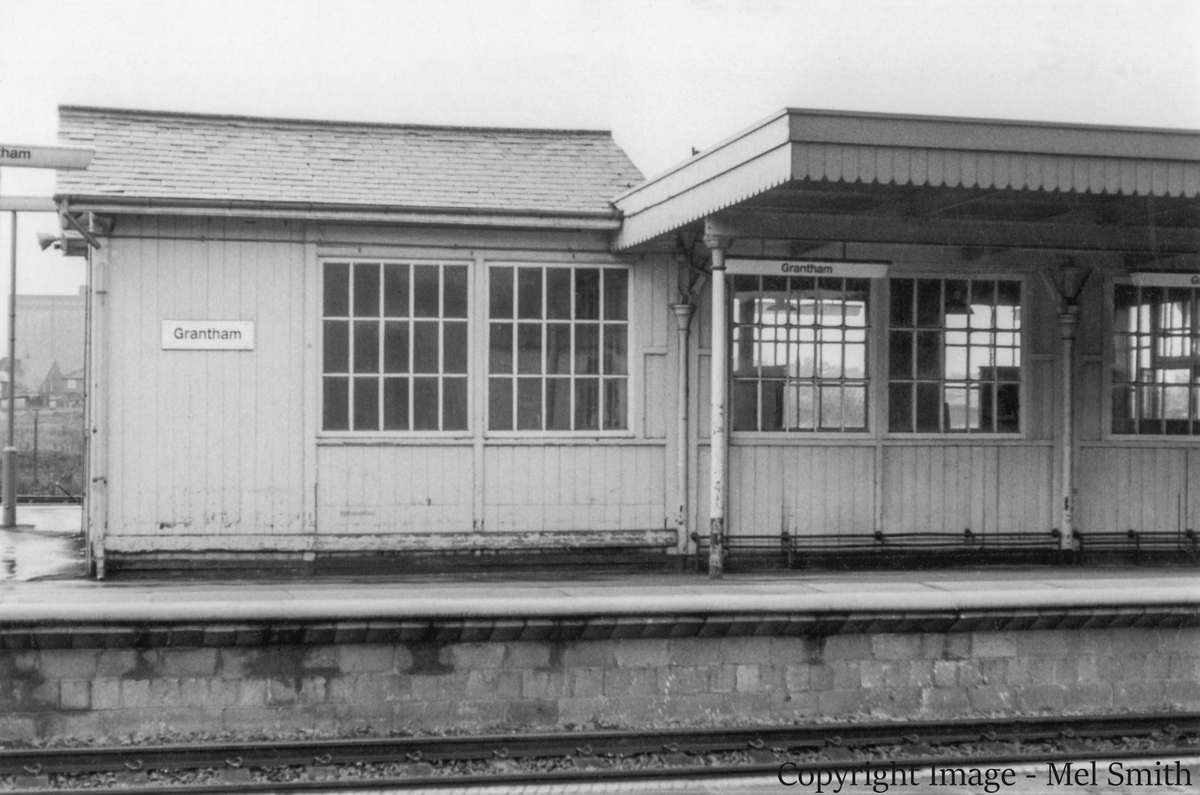 The south end of the main range of buildings on the down platform viewed from Platform 1. The building opposite on the left was the Lamp Room, where oil lamps of all kinds were filled, trimmed and repaired. On the right, in the Tranship Area, consignments of goods awaiting onward shipment by passenger train were stored and sorted. Copyright Image - Mel Smith