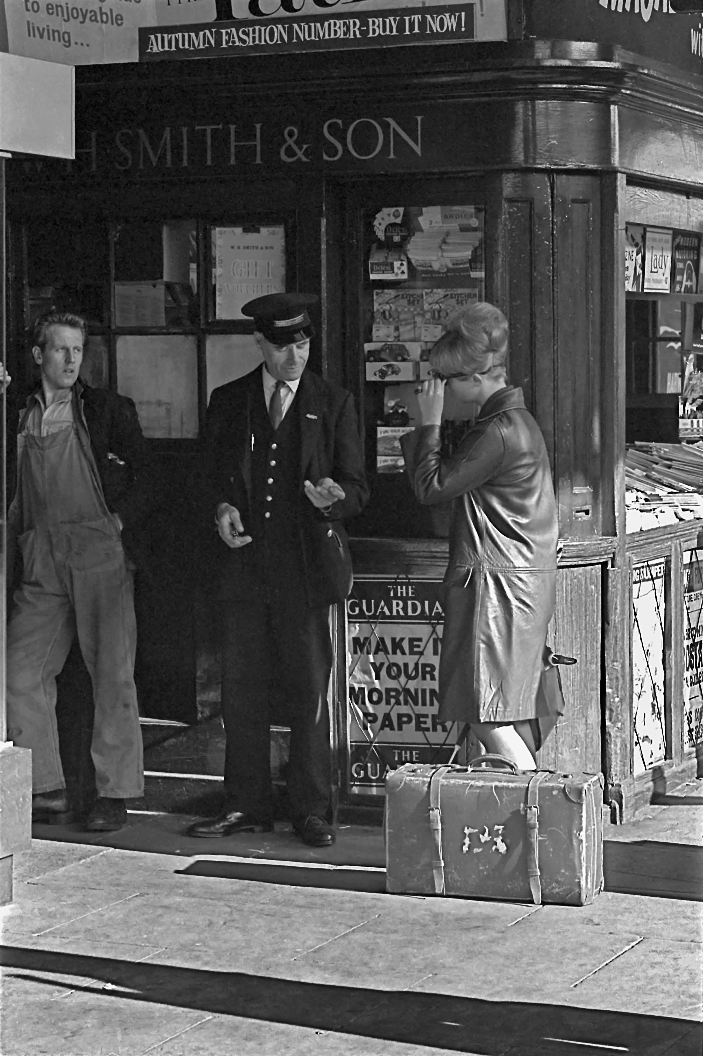 This is one of my favourite photographs. It’s a real early 1960s period piece: the young woman passenger with her stylish ‘hairdo’ yet well-worn suitcase; the ticket collector in his traditional railway staff uniform with waistcoat, shiny metal buttons and peaked cap; the young railwayman in bib-and-brace overalls with pop-star influenced quiff hairstyle idling away a few minutes looking on. George Fielding, a cleaner and fireman at Grantham loco from 17th Jan 1955 until 17th Jan 1964, recognised his friend Alan Grummitt as the young man. Alan was also a cleaner and fireman at Grantham from about 1955 until late in 1963. 19th September 1963 Photograph by Cedric A. Clayson, © John Clayson 