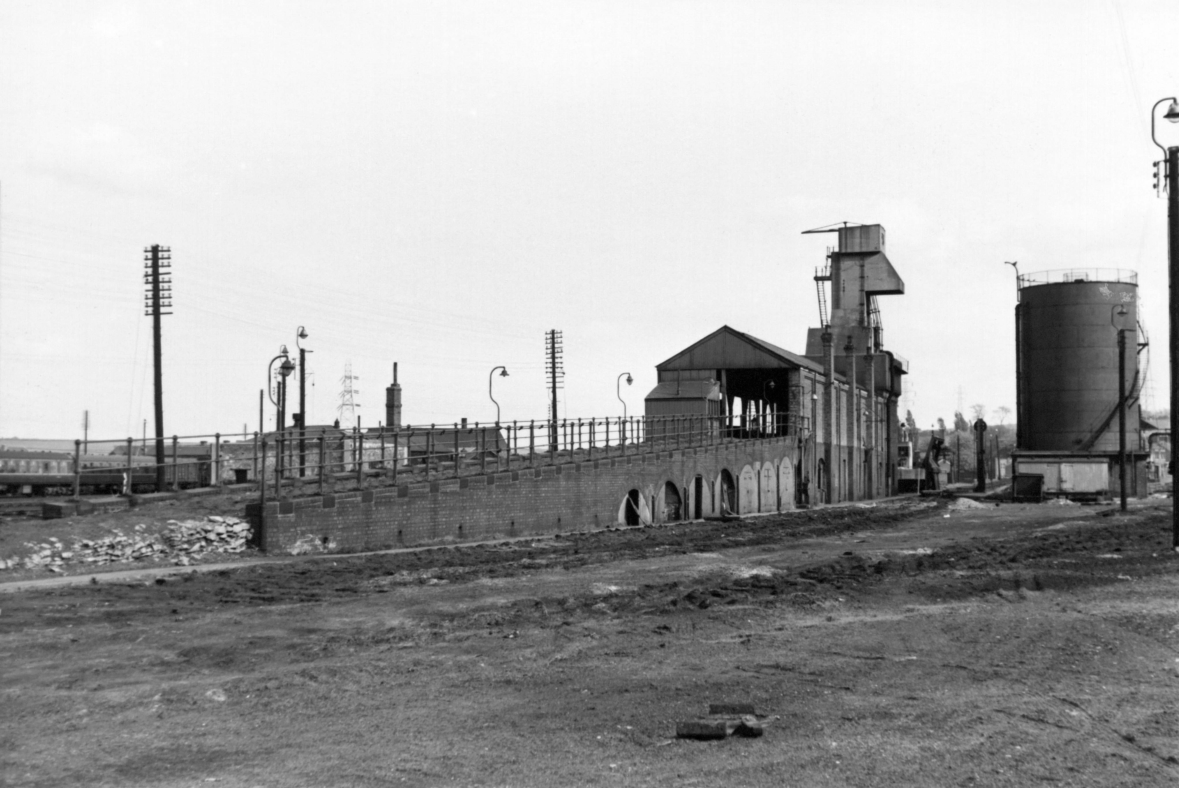The coal stage at Grantham Loco from the north west, showing how the ramp and the stage itself were built like a viaduct, supported on brick arches which were used as messrooms and stores. This photograph was taken in 1964 after the tracks had been lifted but before demolition commenced. Photograph lent by Ken Willetts.