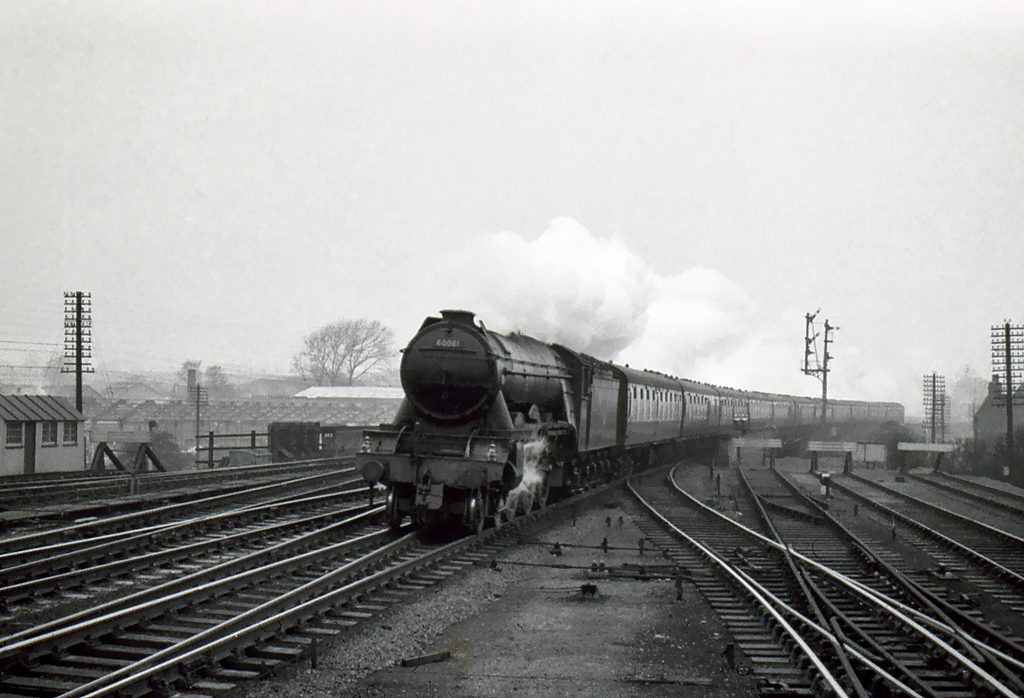 These are the home and distant signals on the approach to Grantham station from the north which Alan regularly spotted from the footplate 'thrusting towards the sky', indicating a clear road through the station and encouragement to make a spirited ascent of the five-mile climb to Stoke Summit. This southbound train on the Up Main line is hauled by A3 locomotive No.60061 Pretty Polly. Photograph by Noel Ingram, with permission from Steam World.