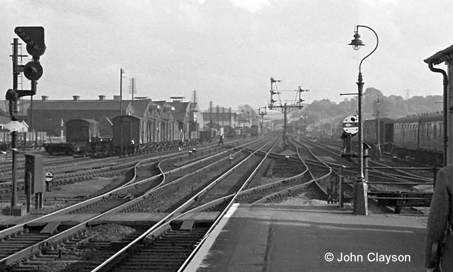 This is an enlarged view of part of the photograph above which shows more clearly the series of crossovers leading to and from the Western platform. These arrangements provided good flexibility of operation in a relatively compact area, at the cost of quite complex trackwork. The crossings required regular maintenance under the heavy traffic conditions of this busy section of the East Coast Main Line. On the left are the up side sidings and goods yard. Despite its proximity and its name by this time there were no connections with these sidings at the Yard Box; the up side sidings connected with the running lines in the distance, at the South Box. Photograph by Cedric A. Clayson