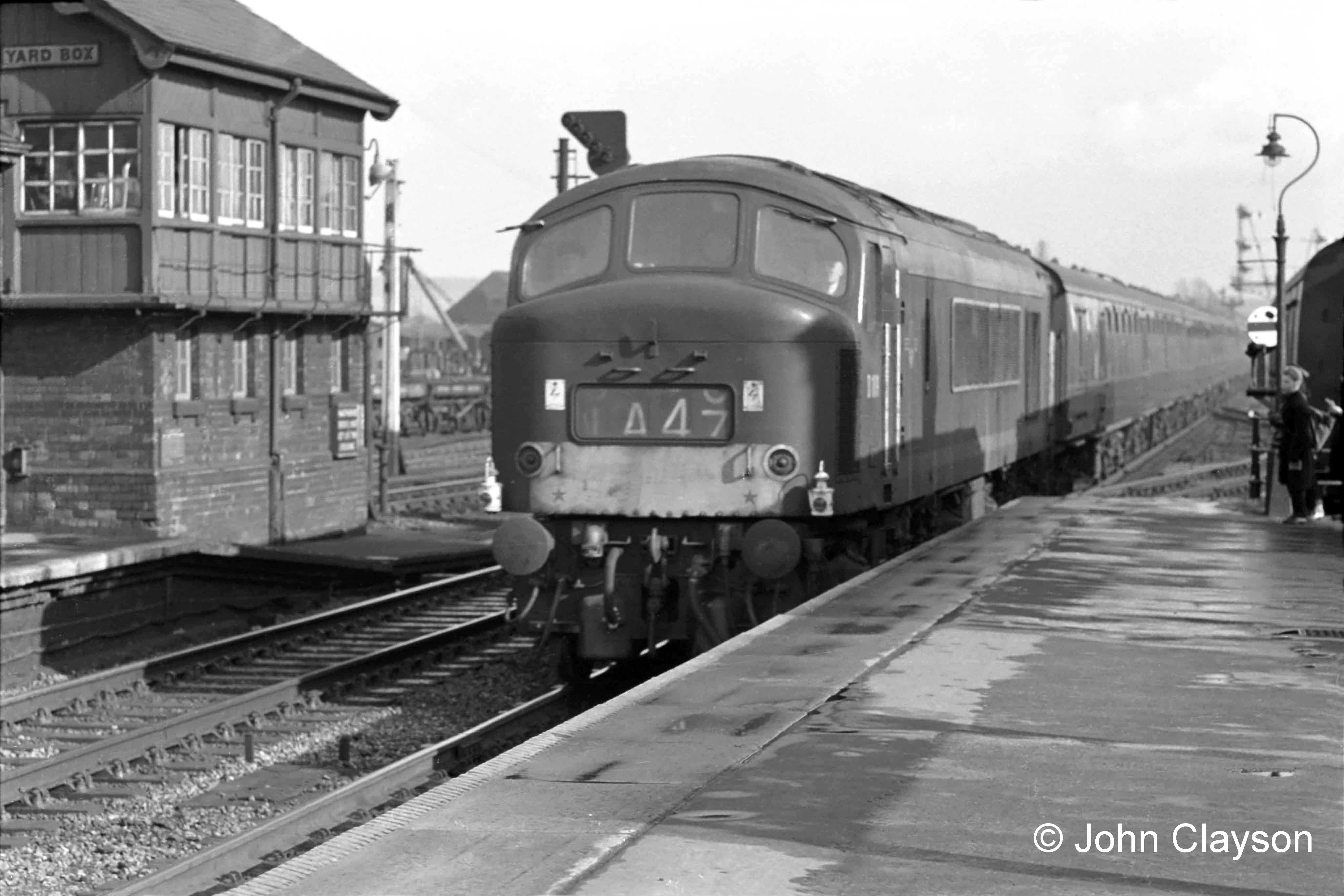 On April 18th 1963 a northbound passenger train passes the Yard Box on the Down Main line, hauled by a diesel electric locomotive of the ‘Peak’ class, so called because the first ten were named after English and Welsh mountains. Train 1A47 would be the southbound The Heart of Midlothian at that time, so it would seem that this locomotive has faulty train indicator blinds. It is also carrying 'Class 1' express passenger train oil headlamps, as used on steam locomotives, which may be intended to show that the indicator blinds are not to be relied upon. Peak locomotives seemed prone to this problem. This could possibly be service 1A42, the 15:00 from King's Cross to Newcastle, which would be at Grantham around 16:45. Photograph by Cedric A. Clayson,