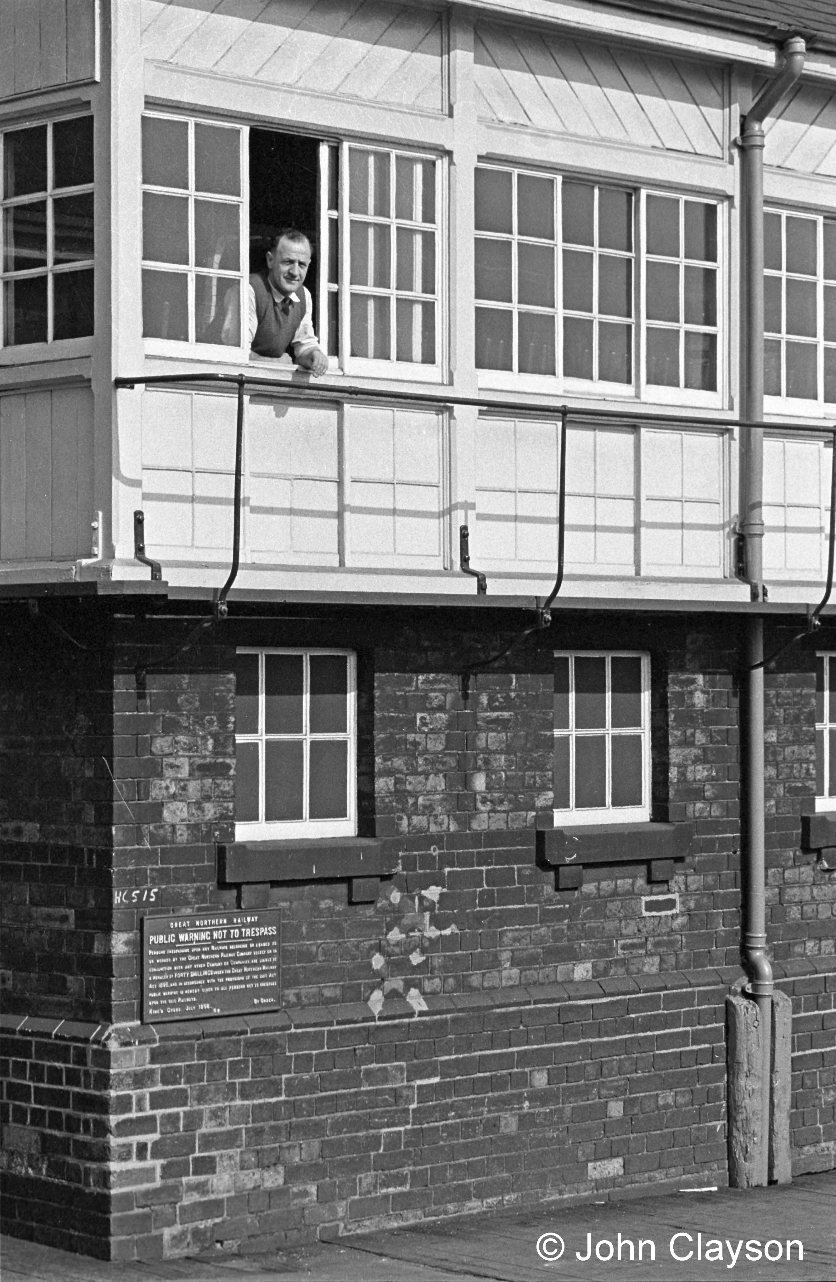 Signalman Jock Drummond is at the window of the Yard Box on 5th September 1963, a fine autumn day. From within you might hear the 'ting' or 'tang' of a block bell, announcing the approach of another train on the main line. What will it be? If you've learned the block signalling bell code you may be able to work it out! Photograph by Cedric A. Clayson.