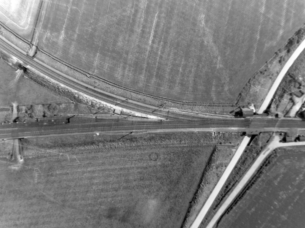 This aerial view of Barkston South Junction shows the signal box middle right with the 'train spotters' mound' on the opposite side of the line, and farm access tunnels through the Main line and Sleaford line embankments at far left.