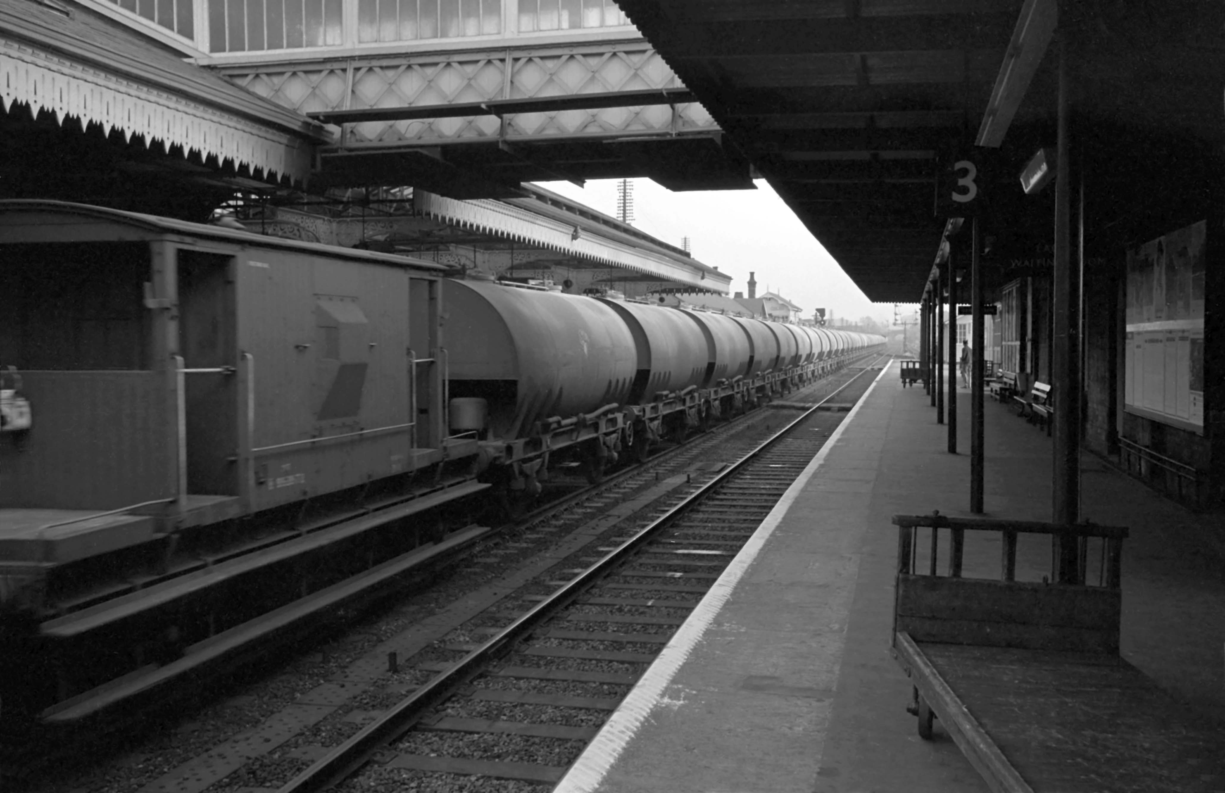 A southbound train of empty 'Cemflo' cement wagons speeds through the station on 3rd October 1963. Photograph by Cedric A. Clayson, © John Clayson