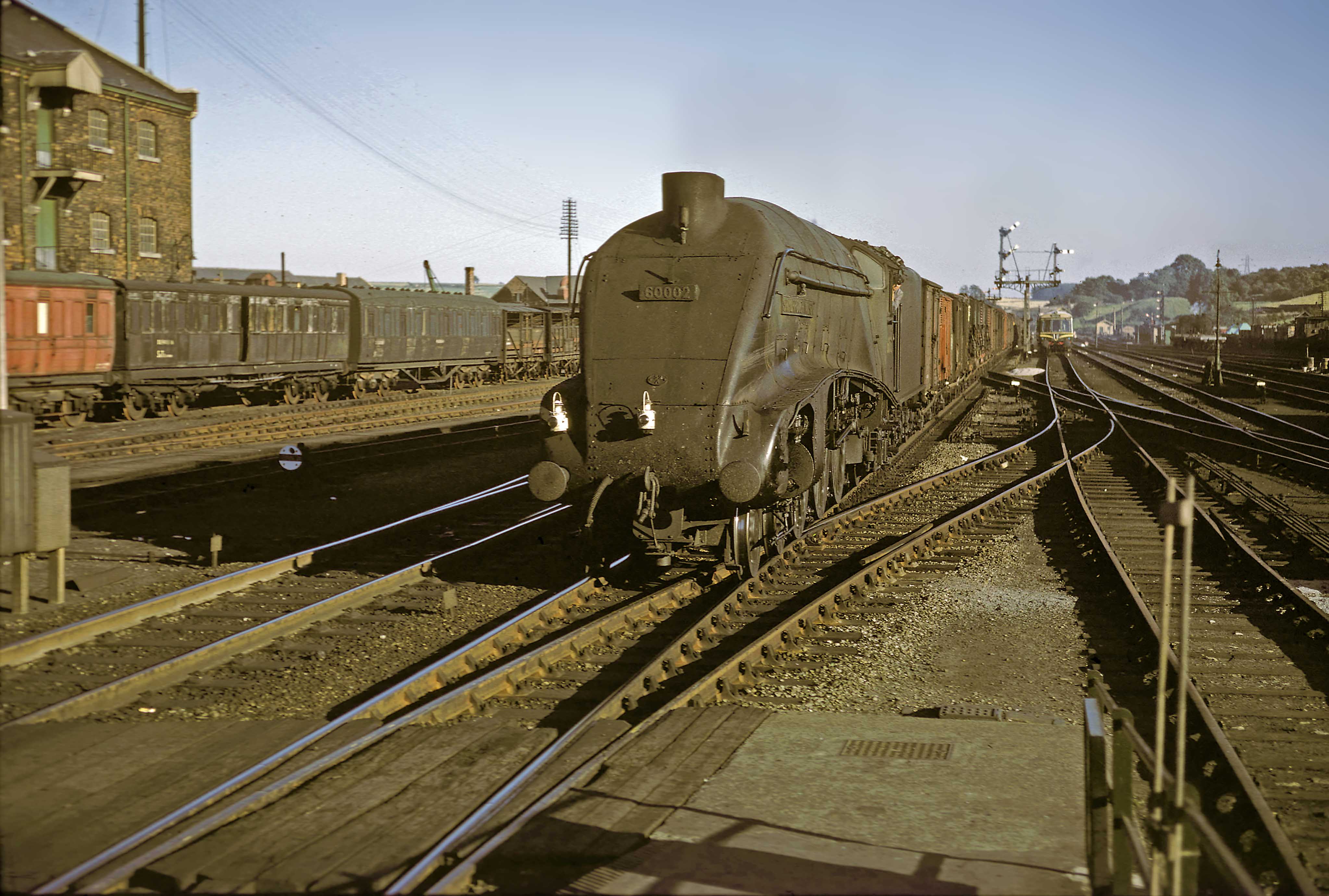 A4 No. 60002 Sir Murrough Wilson of Gateshead (52A) motive power depot approaches the station at speed with a northbound fully fitted express freight train on 31st August 1961. This is thought to be the daily ‘Scotch Goods’ service departing from London King's Cross Goods Depot at 2.55pm for Niddrie, near Edinburgh. Sir Murrough Wilson was the Deputy Chairman of the London & North Eastern Railway. Photograph by Cedric A. Clayson, © John Clayson