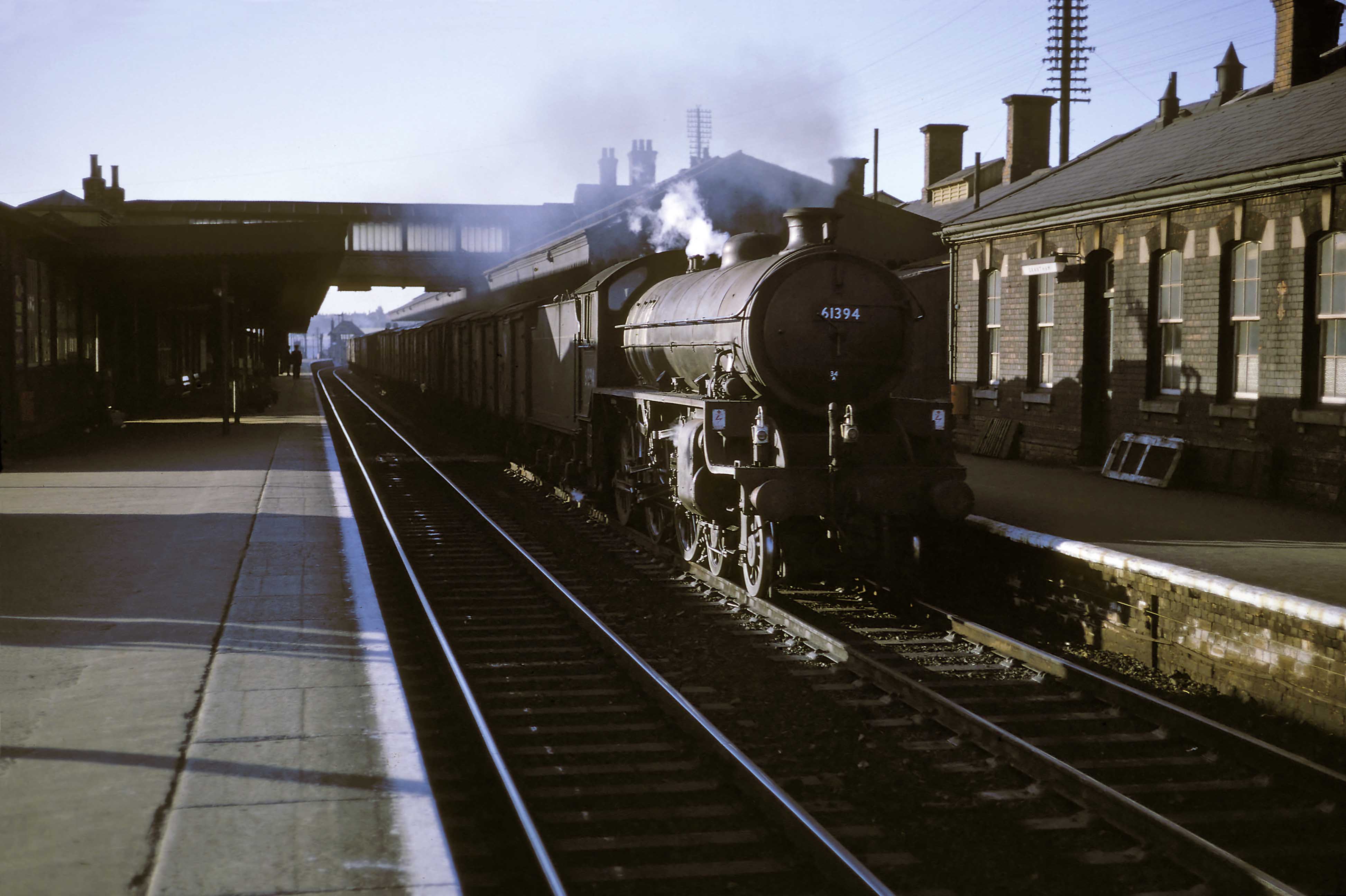 Class B1 No. 61394 of King’s Cross (34A) shed begins the climb to Stoke Summit with a fish train for London on 31st August 1961. The light haze from the chimney shows that the fireman has everything well in hand for a good run up to Stoke summit, and surely the catch will be at Billingsgate Market on time next morning. This is likely to be the afternoon fish train from Hull to King's Cross Goods Depot. It left Hull around 3.40pm, regularly hauled by this locomotive or its consecutively numbered sister No. 61393. Photograph by Cedric A. Clayson, © John Clayson