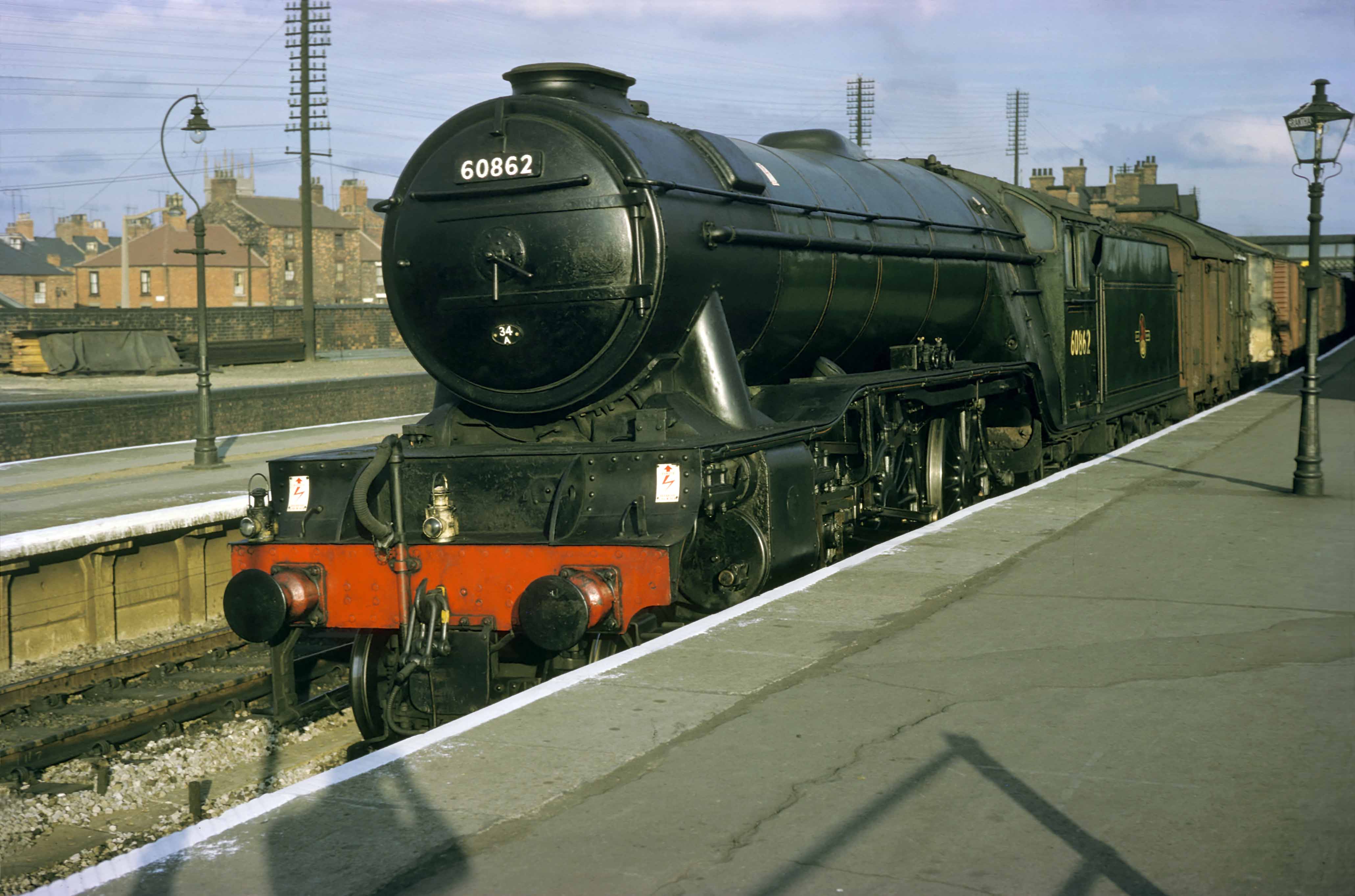 A northbound express freight on 21st or 28th June 1962, hauled by class V2 locomotive No. 60862 of King’s Cross (34A) motive power depot. This is thought to be a service which left King's Cross Goods Depot at about 3.40pm. The King's Cross engine and men worked the train to York, where they lodged overnight and returned the following day on an Inverkeithing to King's Cross express freight. Photograph by Cedric A. Clayson, © John Clayson