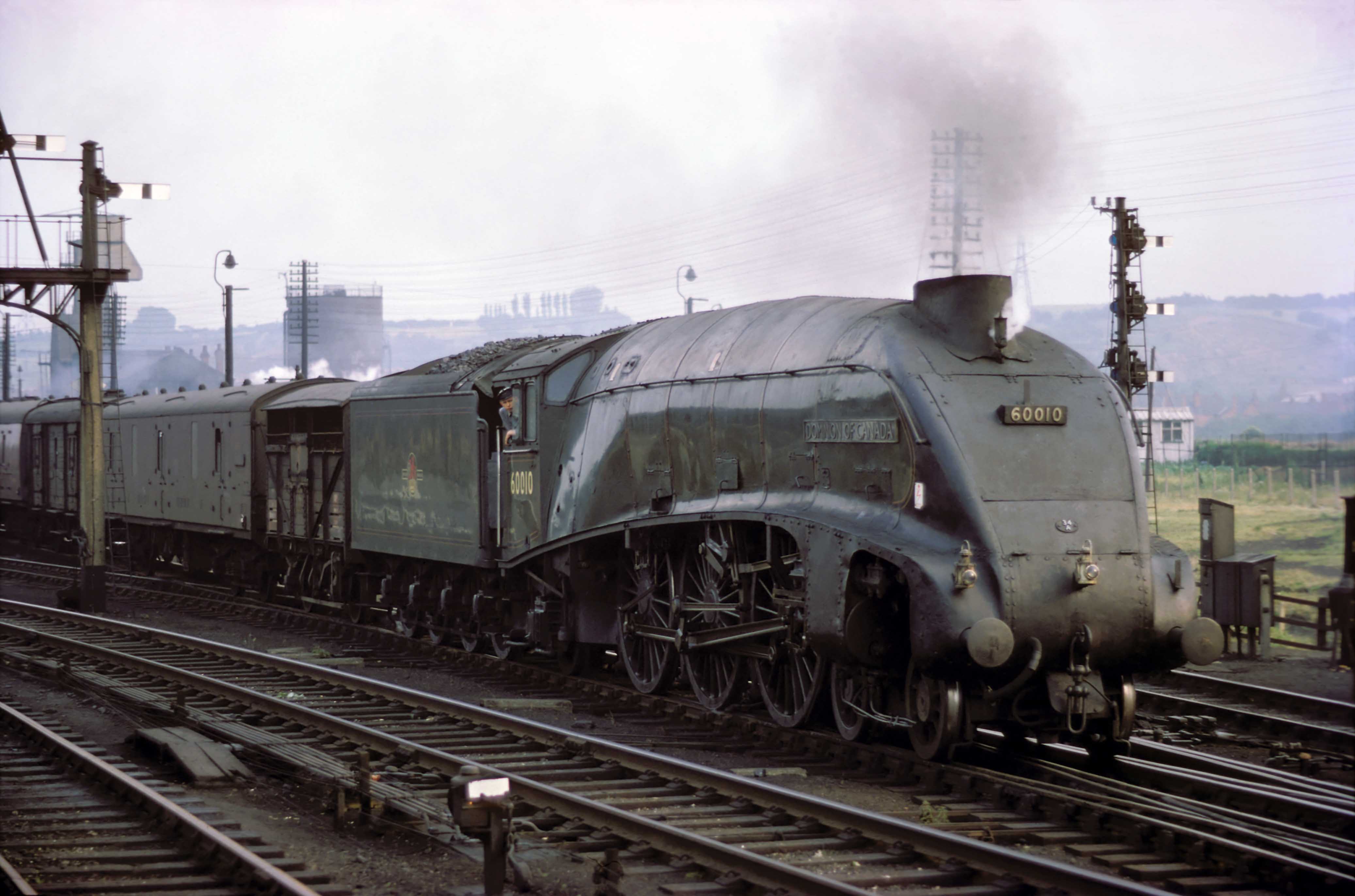Class ‘A4’ locomotive No. 60010 Dominion of Canada has charge of a northbound fully fitted express freight train on 12th July 1962. It has paused on the Up & Down Goods line and sets off once more on its journey. Photograph by Cedric A. Clayson, © John Clayson
