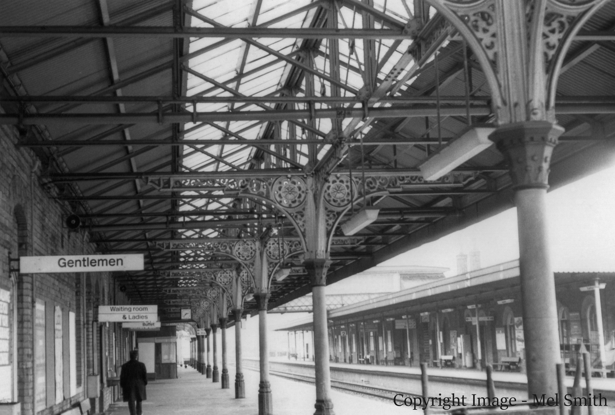 A general view looking south from the northern end of platform 1. The main buildings on platform 2 can be seen on the right across the main lines. Copyright Image - Mel Smith
