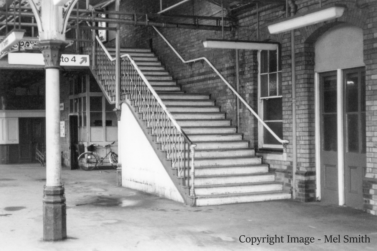 The stairs from platform 1 leading to the footbridge across to platform 2. The two doors positioned at the bottom of the stairs are an entrance to a Battery Room (left) and Lobby (right) Copyright Image - Mel Smith