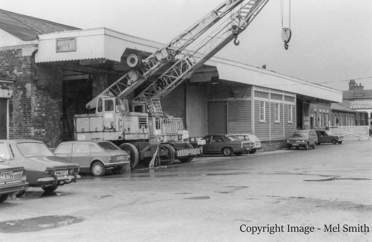 Mobile cranes positioned outside the Post Office buildings, the former Goods Shed, on Station Road. The main entrance to the station can be seen in the far distance. Copyright Image - Mel Smith