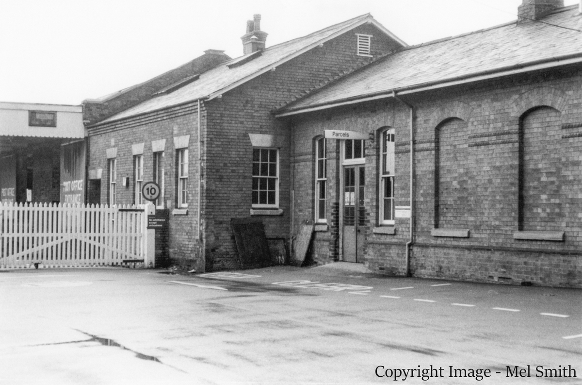 The entrance gates to the Goods Yard and Post Office buildings eventually come into view. From right to left the Station Master's Office, the Telegraph Office, a cycle store and the Parcels Office. Copyright Image - Mel Smith