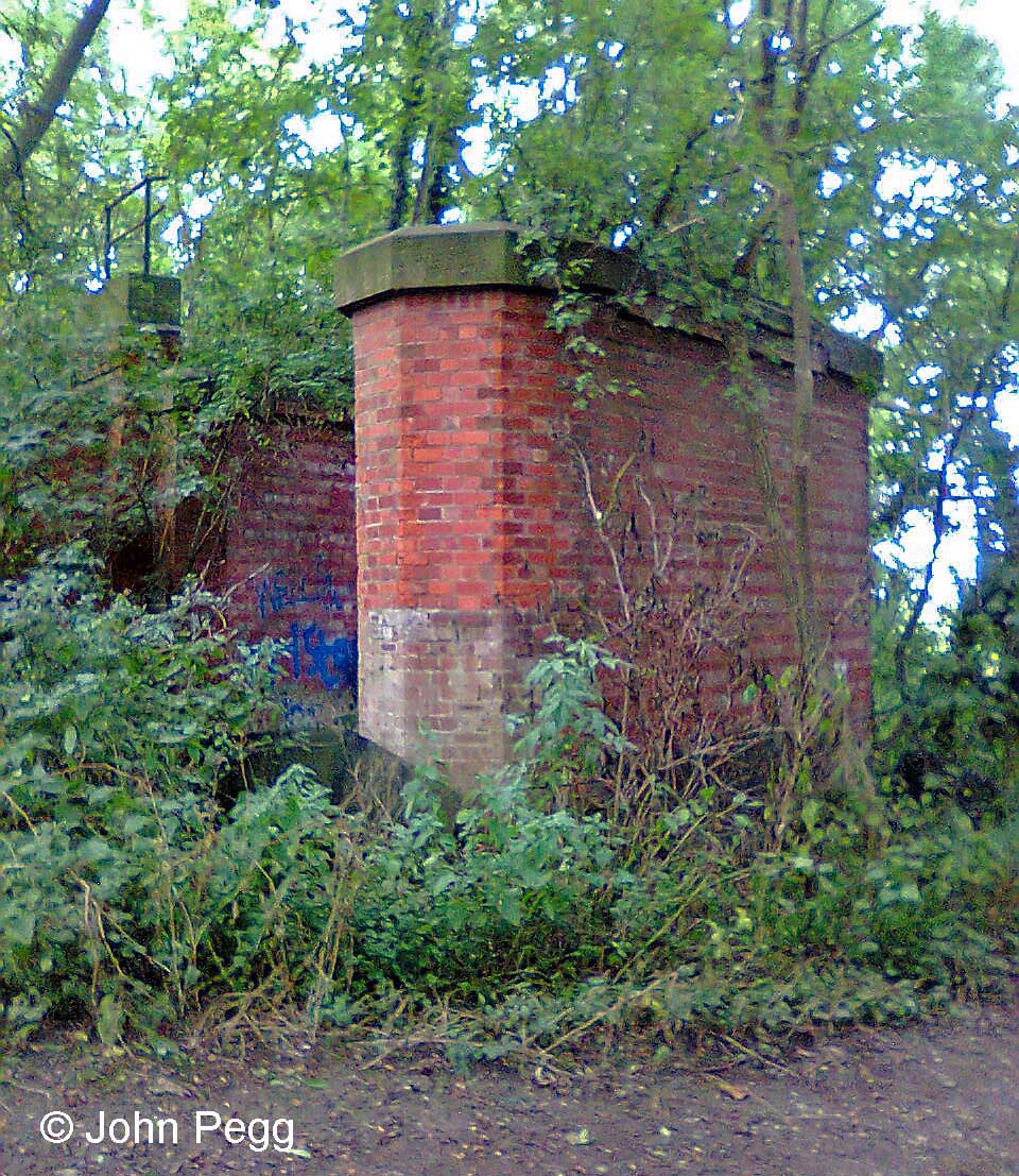 This is part of the brickwork of a bridge which took the branch over Longmoor Lane - the west abutment and a central pier. Today Longmoor Lane is a quiet bridleway, but it must have been busier when the railway was built to justify such a substantial two-span bridge.